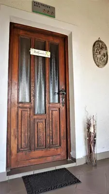 a wooden door with a sign in front of it at Vineyard Cottage Zajc in Semič