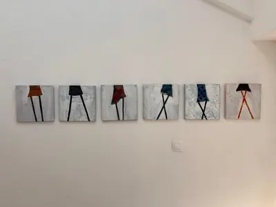 a row of paintings hanging on a wall at Villa Boris in Starše