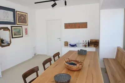 a dining room with a wooden table and chairs at Villa Boris in Starše
