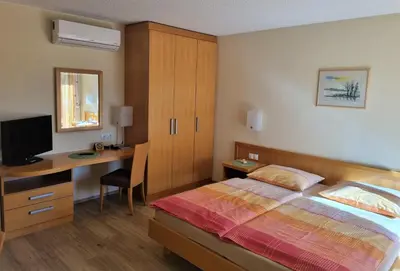 a bedroom with a bed and a desk with a computer at Apartments AD Radenci in Radenci