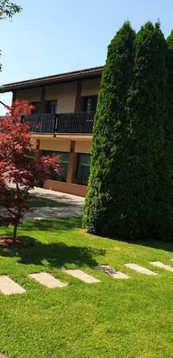 a large bush in front of a building at Apartments AD Radenci in Radenci