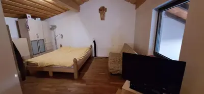 a small bedroom with a bed and a tv at Prenočišče pri Sodarju in Beltinci