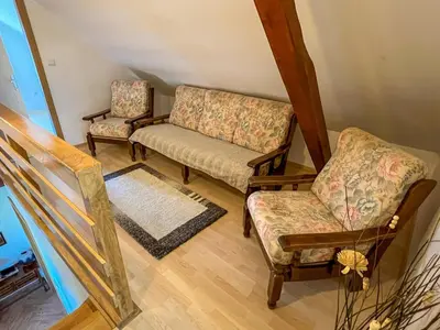 a living room with two chairs and a couch at POČITNIŠKA HIŠA SONČNI VRH in Spodnji Ivanjci