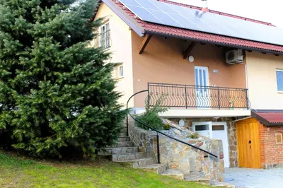 a house with solar panels on the roof at POČITNIŠKA HIŠA SONČNI VRH in Spodnji Ivanjci