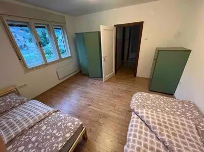 a room with two beds and two windows at Tiny Bled house in Bled
