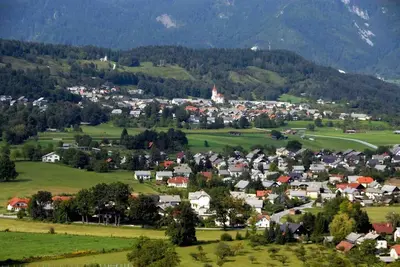 a small town in a green valley with mountains at Tiny Bled house in Bled