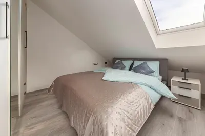 a bedroom with a bed and a window at Luiza's Apartment in Ljubljana
