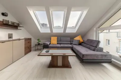 a living room with a couch and a table at Luiza's Apartment in Ljubljana