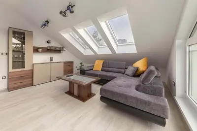 a living room with a couch and a table at Luiza's Apartment in Ljubljana