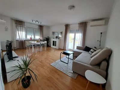 a living room with a couch and a table at Charming Celje City Center Apartment in Celje