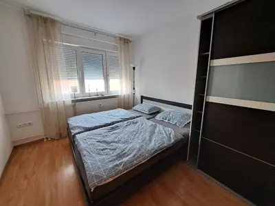a bedroom with two beds and a window at Charming Celje City Center Apartment in Celje