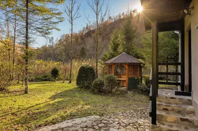 a gazebo on the side of a house at Cabin by the river Polhov Gradec in Polhov Gradec