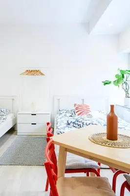 a dining room with a table and a bed at The Urban Loft in Ljubljana