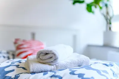 a pile of towels sitting on top of a bed at The Urban Loft in Ljubljana