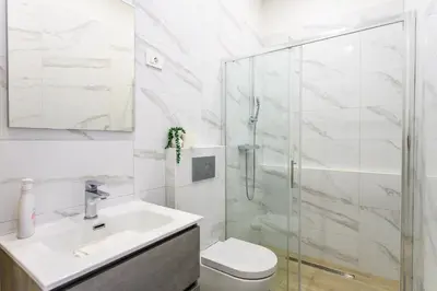 a bathroom with a shower and a toilet and a sink at The Urban Loft in Ljubljana