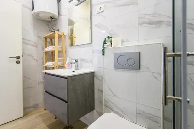 a bathroom with a sink and a mirror at The Urban Loft in Ljubljana