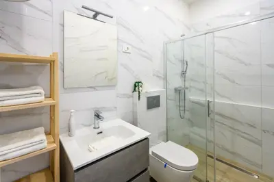 a bathroom with a shower and a sink and a toilet at The Urban Loft in Ljubljana