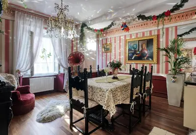 a dining room with a table and a chandelier at Mondo Diverso in Ljubljana