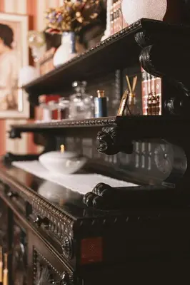 a mirror on a shelf with some items on it at Mondo Diverso in Ljubljana