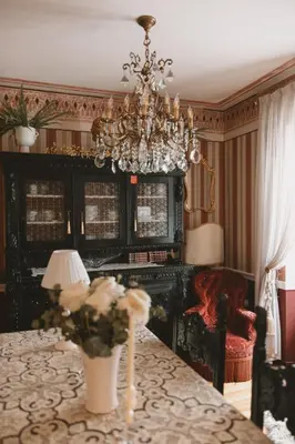 a dining room with a chandelier and a table at Mondo Diverso in Ljubljana