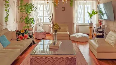 a living room with a couch and a table at Mondo Diverso in Ljubljana