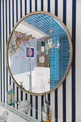 a mirror on a shelf in a bathroom at Mondo Diverso in Ljubljana