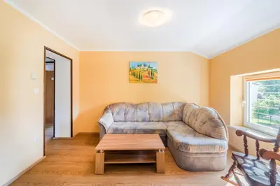a living room with a couch and a table at Apartments Orhideja in Tolmin