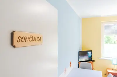 a room with a bed and a sign that reads somewhere at Apartments Orhideja in Tolmin