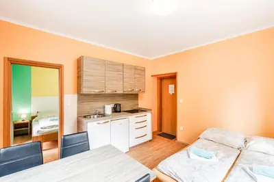 a kitchen with two beds in a room at Apartments Orhideja in Tolmin