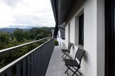two chairs sitting on the balcony of a house at Apartments Repinc in Bled