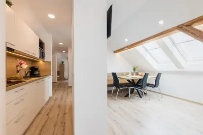 a kitchen and dining room with a table and chairs at Apartments Repinc in Bled