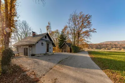 a small house on a road in a field at Oddih ob Krki in Škocjan
