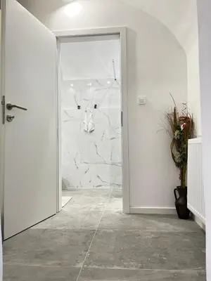 an open door in a room with a stone wall at Under Castle Apartment in Ljubljana