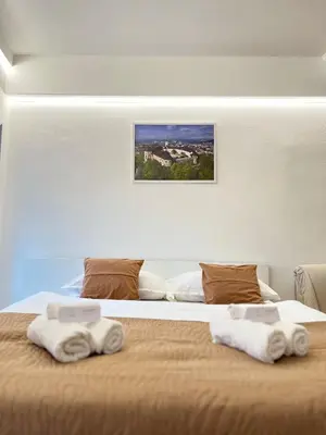 a bedroom with a bed with towels on it at Under Castle Apartment in Ljubljana