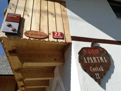 a wooden sign on the side of a building at Apartment Ivanka Cvetek in Bohinj