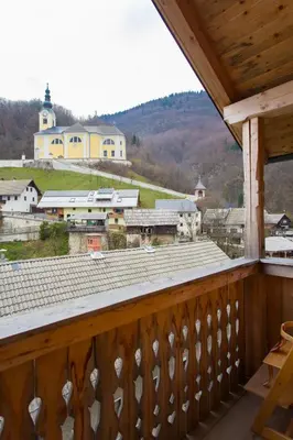 a balcony with a view of a town and a church at Apartment Ivanka Cvetek in Bohinj