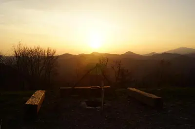 a playground with the sunset in the background at Apartments Lom in Most na Soči
