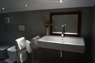 a bathroom with a white sink and a toilet at Apartments Lom in Most na Soči