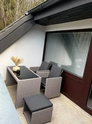 a patio with chairs and a table and a door at Golden hour apartment in Kranjska Gora