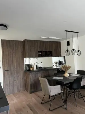 a kitchen and dining room with a table and chairs at Golden hour apartment in Kranjska Gora