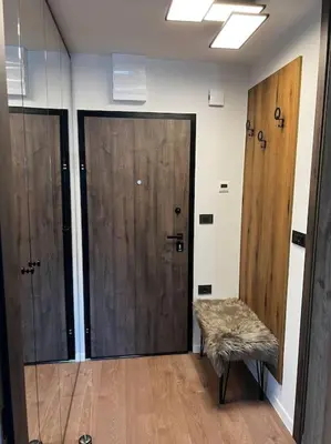 a hallway with two doors and a bench in a room at Golden hour apartment in Kranjska Gora