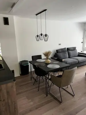 a living room with a table and a couch at Golden hour apartment in Kranjska Gora