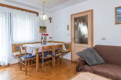 a living room with a table and a couch at Holiday Home Pri Srni in Bohinj