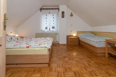 a bedroom with two beds and a window at Holiday Home Pri Srni in Bohinj