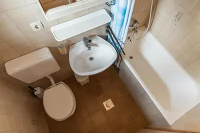 a bathroom with a toilet and a sink and a tub at Holiday Home Pri Srni in Bohinj