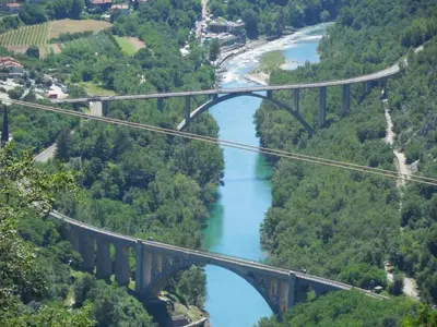 a suspension bridge over a river in the mountains at Tami in Lokve