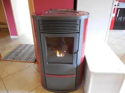 a fireplace in a room with a fire in it at Tami in Lokve