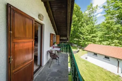 a door to a balcony with a view of a yard at Tami in Lokve