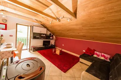 a large living room with a red wall at Tami in Lokve