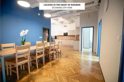 a dining room with a long table and chairs at CafDorm in Maribor